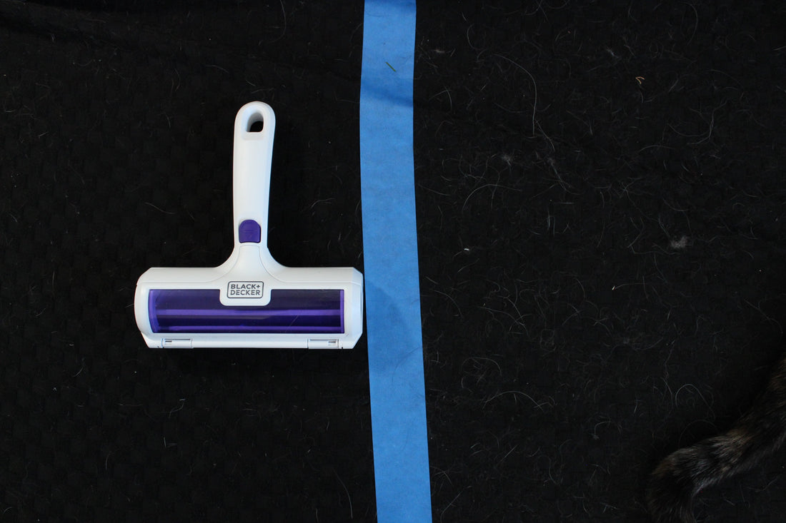 Black+Decker pet hair remover after rolling on a fabric surface, showing the right side cleared and left side still covered in hair