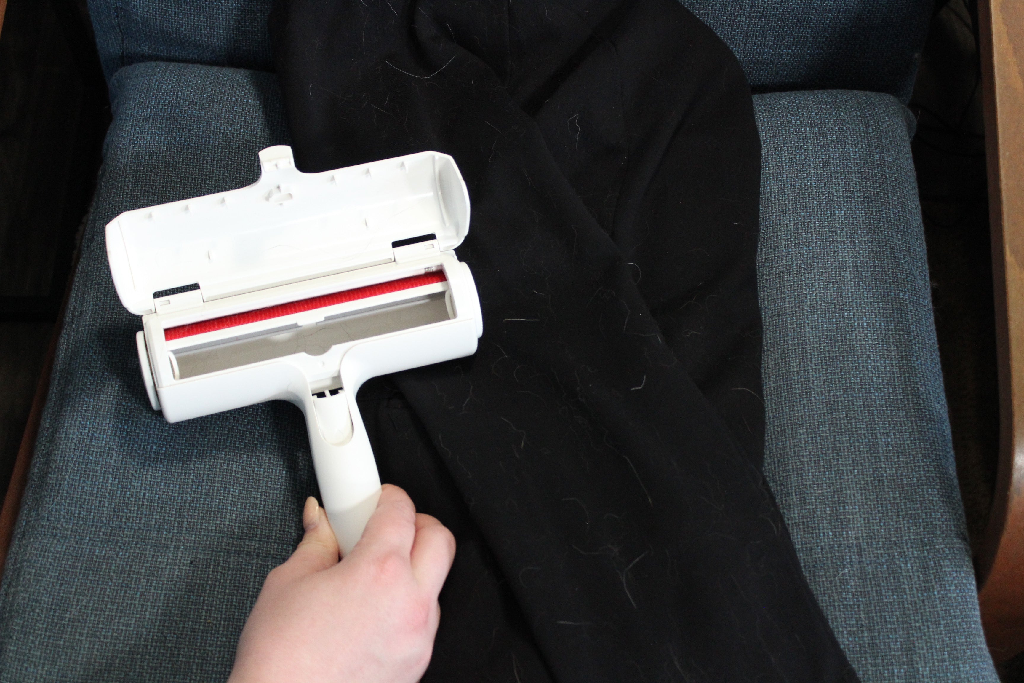 ChomChom roller with the chamber open after a clothing test, showing minimal hair collected because the loose fabric did not provide tension for the fabric strips to grip